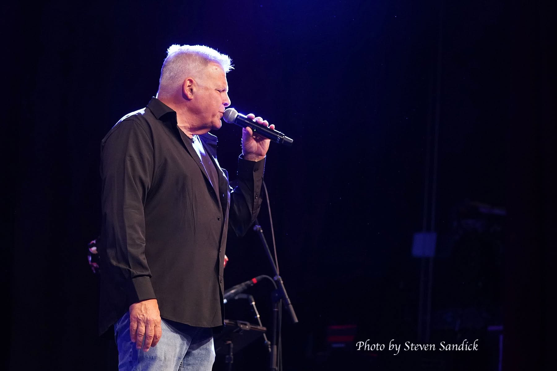Jim DeRosa singing on stage