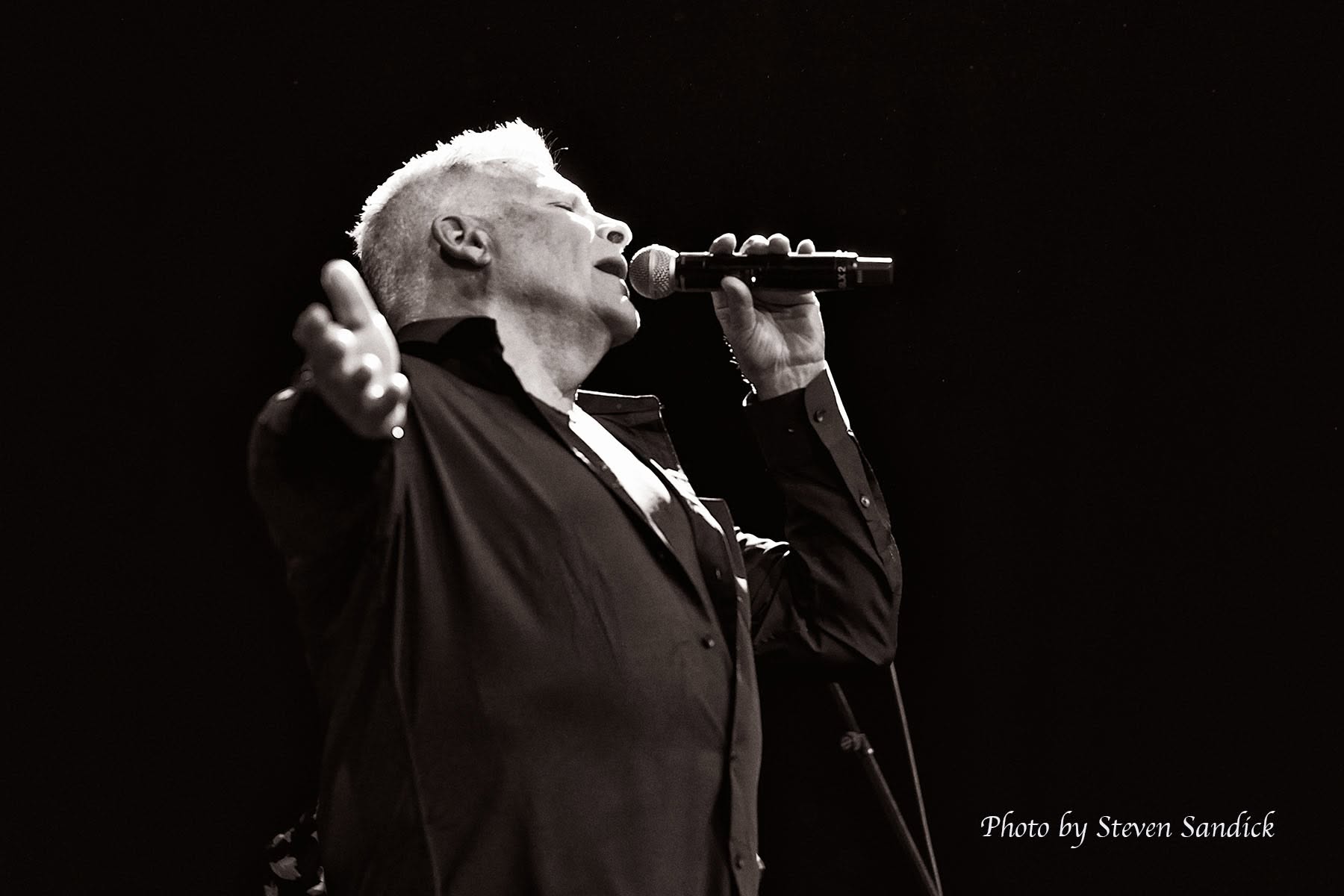 Black and white photo of Jim DeRosa singing