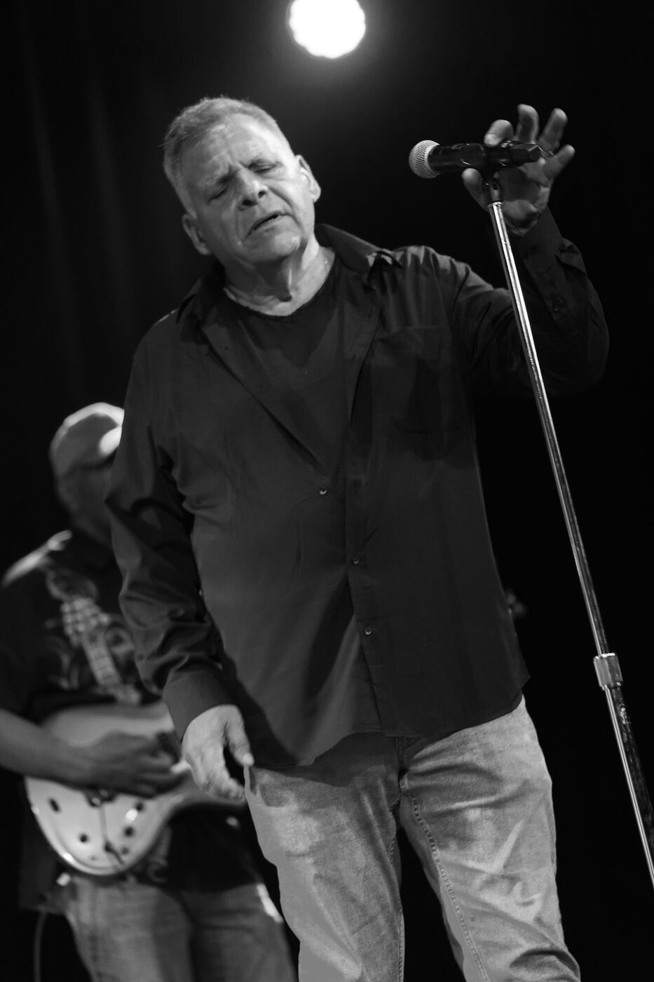 Black and white photo of Jim DeRosa singing